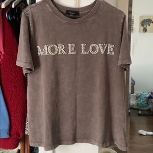 Graphic T. Says “more love” on front.